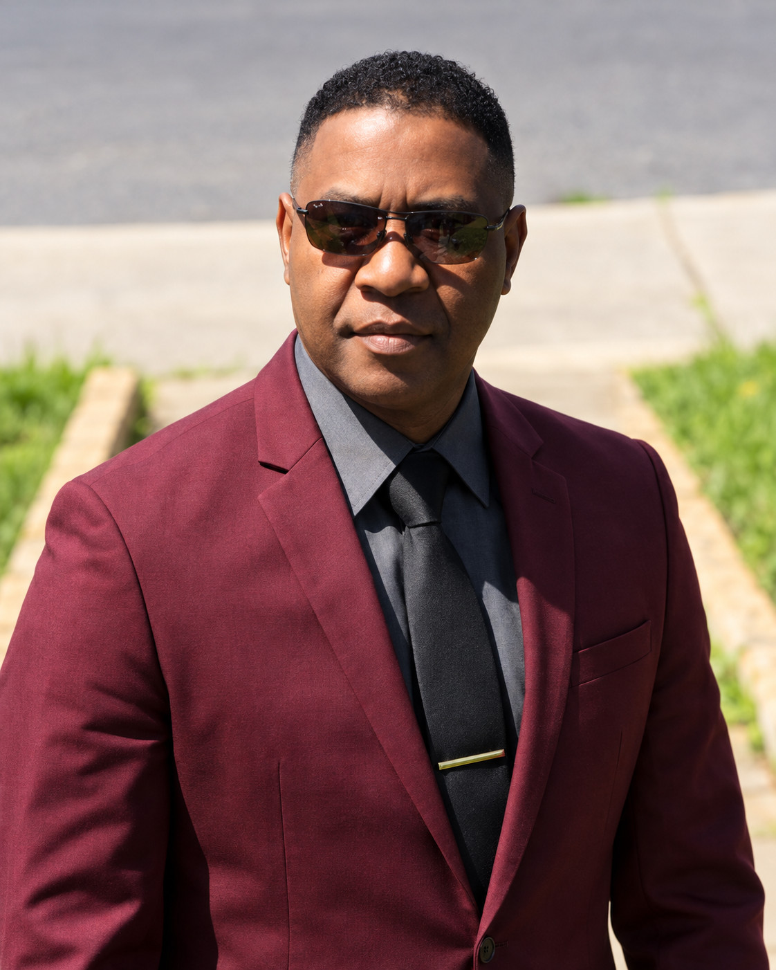 Astrel Phebe in a burgundy jacket and sunglasses